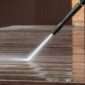 Man pressure washing wooden deck and walls 85x85