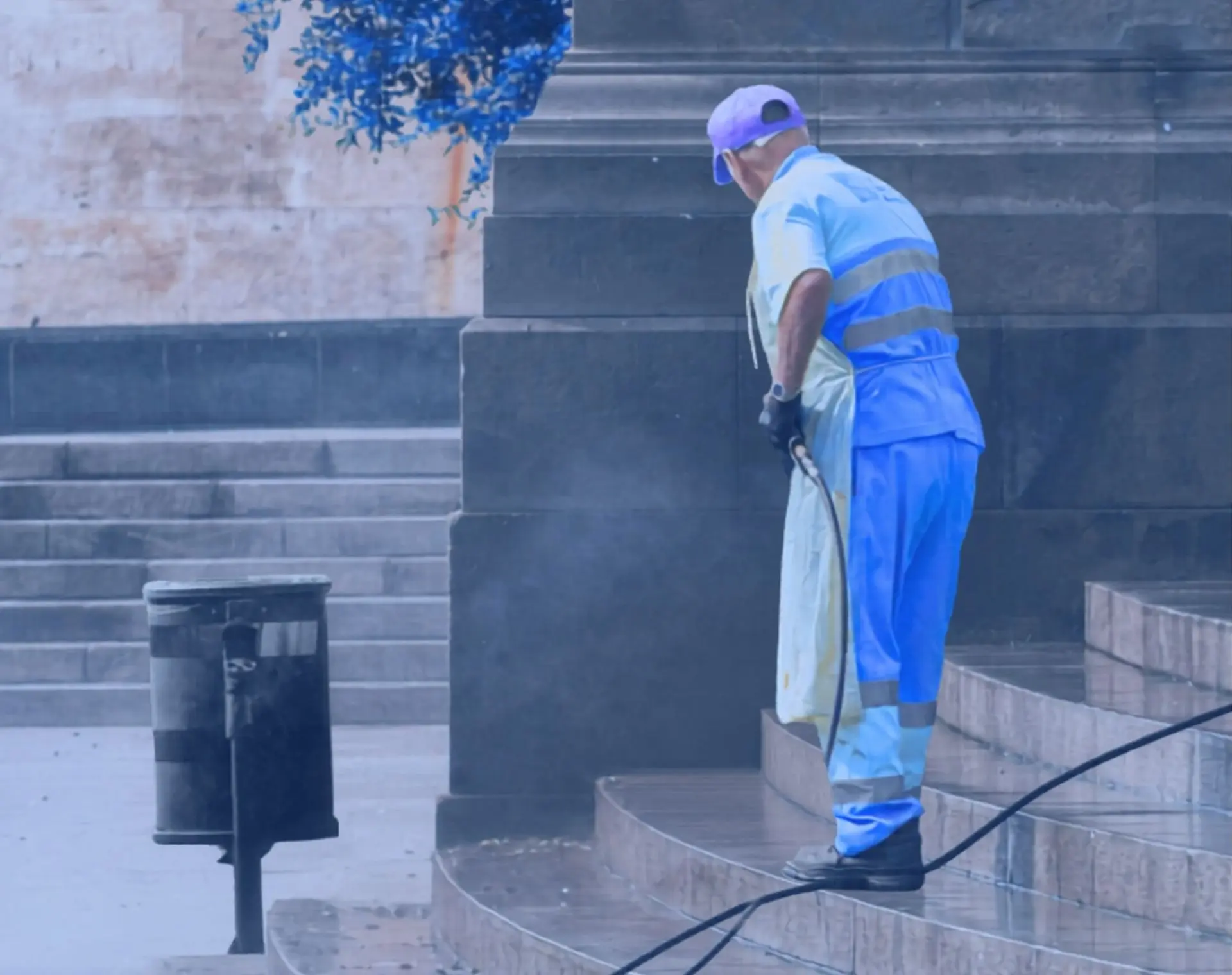 Pressure washing technician cleaning a commercial building entrance in Fort Collins